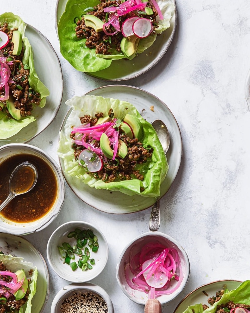 The image shows several white plates arranged on a white marbled surface, each holding a lettuce wrap with three visible layers: a base of crisp pale green lettuce leaves, a middle layer of cooked brown ground meat mixed with herbs and small pieces of vegetables, and a top layer of vibrant pink pickled onion slices, pale green avocado slices, and thin red-rimmed white radish slices, all sprinkled with light brown sesame seeds. Around the plates, there are small white bowls holding extra pink pickled onions, dark brown sauce, black and white sesame seeds, and bright green chopped vegetables. One silver spoon with some sauce rests on one plate, and a woman’s hand is gently holding one lettuce wrap on a plate. The overall look is fresh, colorful, and clean. photo taken with an iphone --ar 4:5 --v 7