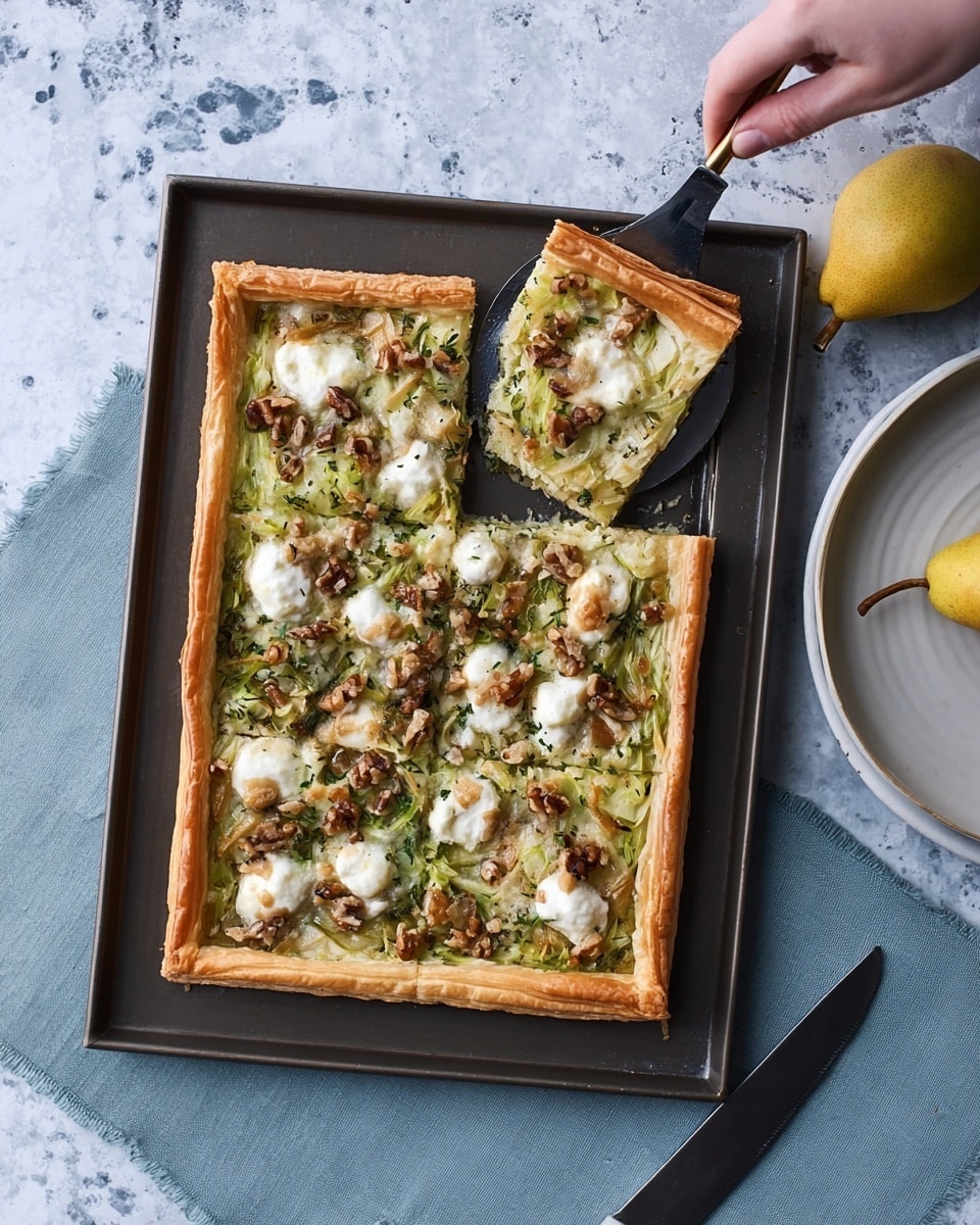 A rectangular tart with a golden-brown puff pastry crust is on a dark baking tray, placed on a white marbled surface. The tart has evenly spread layers including a white creamy cheese base, topped with green cooked vegetables and scattered dollops of soft white cheese. There are small pieces of walnuts sprinkled over the top, adding texture and warmth in color. A square slice is being lifted by a woman's hand from the left side, showing the layers clearly. Below the tray is a white plate with a yellow pear on a grey cloth. Photo taken with an iphone --ar 4:5 --v 7