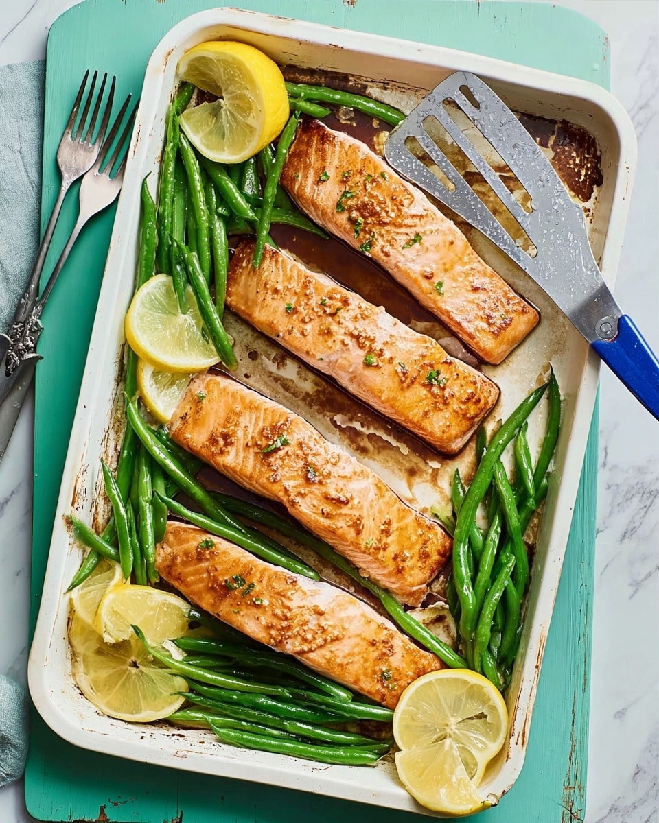 The image shows a white baking tray with three cooked salmon fillets placed in a row. The salmon has a light brown, slightly glazed surface with a moist texture. Around the salmon, there are several green beans arranged in small bunches, adding a fresh green color. Four lemon wedges are scattered on the tray, showing a vibrant yellow inside. A metal spatula with a blue handle rests on the right side of the tray, partly on the salmon. The tray is set on a white marbled surface with a pale blue wooden board underneath, and part of a woman's hand holding a green fork appears at the top left corner. Photo taken with an iphone --ar 4:5 --v 7