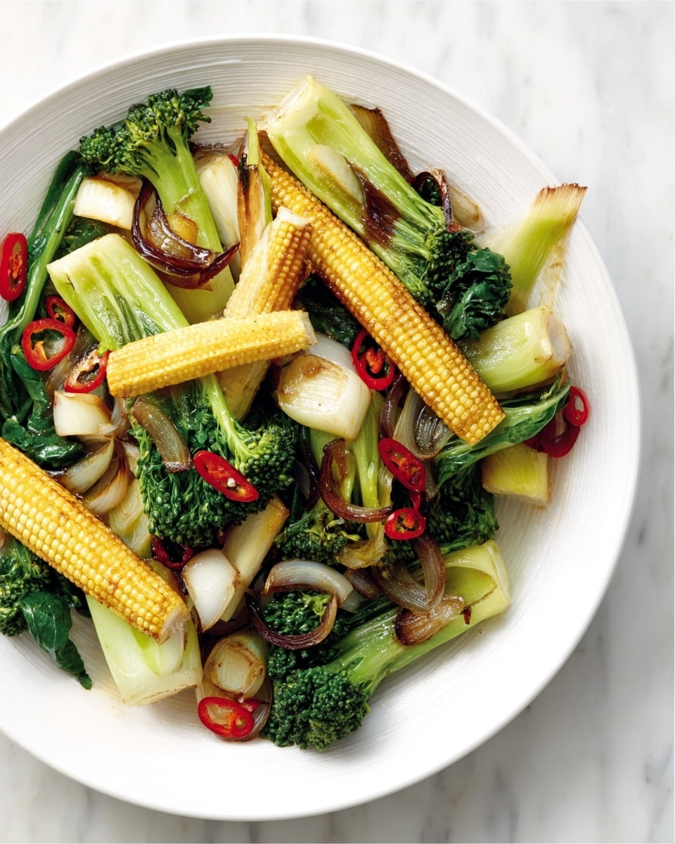 The image shows a white bowl filled with a colorful mix of cooked vegetables. The bottom layer has light green and pale yellow pieces of bok choy with soft, smooth texture. On top of this are bright green broccoli stems with tiny florets, giving a slightly rough texture. Thin, yellow baby corn with visible kernels are arranged across the dish in a scattered way. Small slices of red chili pepper add bright red spots, and some light brown sautéed onion slices bring a soft, glossy texture throughout. The bowl is placed on a white marbled surface. photo taken with an iphone --ar 4:5 --v 7