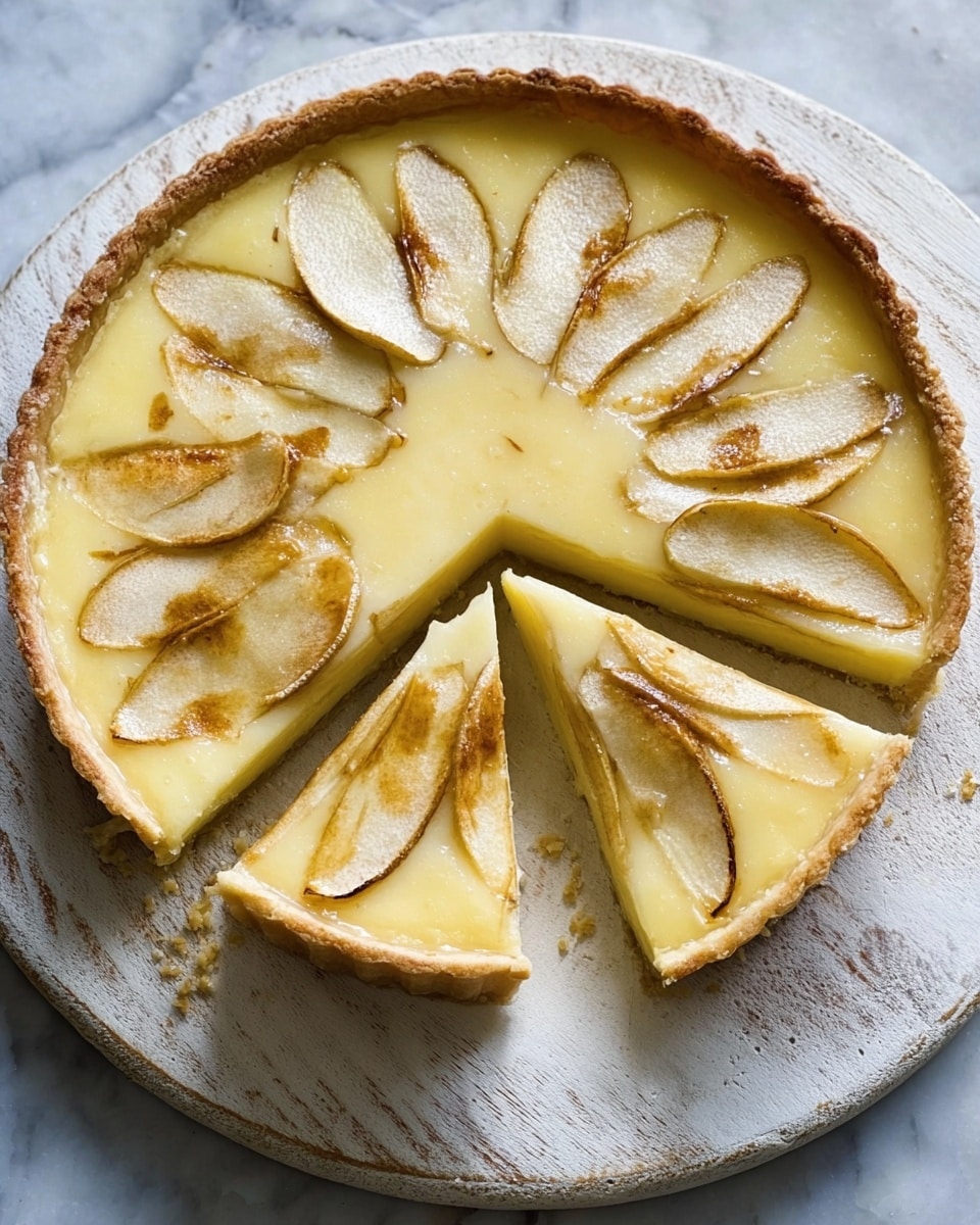 A round pie with a light golden crust sits on a round wooden board over a white marbled surface, with one large slice and one small slice cut and slightly pulled away from the main pie. The top layer is a smooth, pale yellow filling with glossy texture, decorated with thin, lightly browned pear slices arranged in a circular pattern around the pie. The crust edges are slightly thick and evenly baked. Photo taken with an iphone --ar 4:5 --v 7