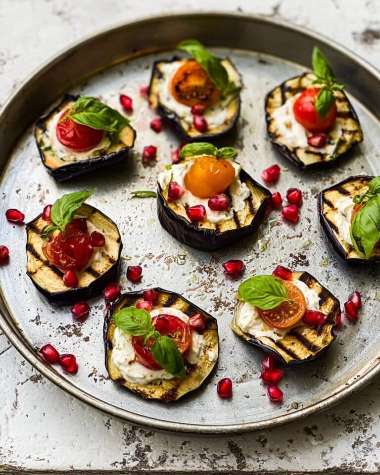 Grilled Aubergine Stacks with Hummus, Pomegranate Seeds, and Cherry Tomatoes Recipe