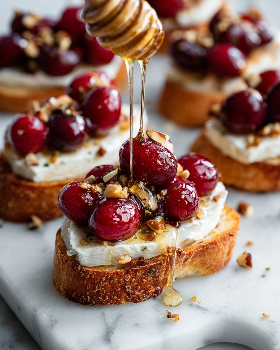 A close-up of a round toasted bread slice with a golden crust serving as the base layer, topped with a white creamy layer of melted cheese. On top of the cheese, there are deep red roasted cherries and small pieces of chopped nuts scattered around. A thin stream of honey is being poured over the cherries, creating shiny droplets that catch the light. The toasts are arranged on crumpled white parchment paper against a white marbled texture surface. Photo taken with an iphone --ar 4:5 --v 7
