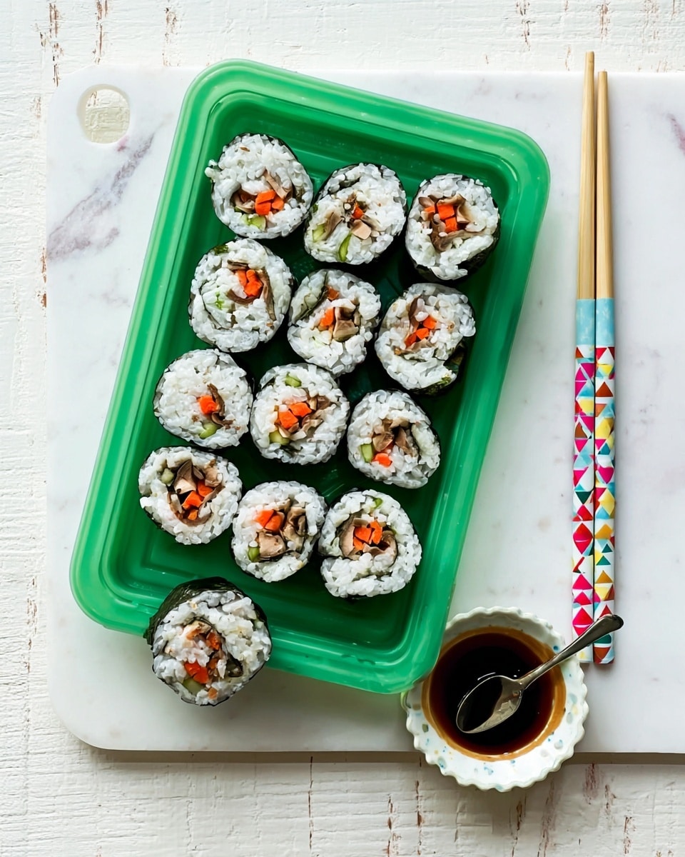 The image shows a green tray filled with eight pieces of sushi rolls, each with white rice surrounding colorful fillings of red, orange, and light brown, wrapped in dark seaweed. One sushi roll is outside the tray, placed near a small white plate with some dark soy sauce. A pair of white chopsticks with a colorful patterned wrapper rests next to the tray on a white marbled surface. A woman's hand is not visible, but the chopsticks are ready to be picked up. The overall setting is bright and clean. photo taken with an iphone --ar 4:5 --v 7