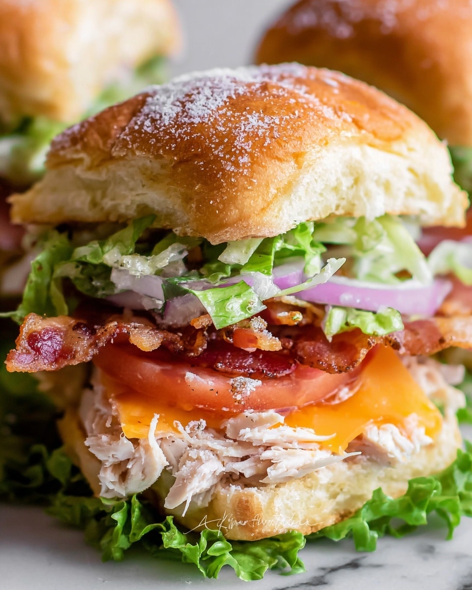 The image shows a close-up of a sandwich with three visible layers. The top layer is a golden brown bread roll with a light dusting of white seasoning, rough in texture. Below it, there is fresh green lettuce followed by crisp slices of red tomato and thin purple onion strips. Under these vegetables, a layer of shredded white meat is visible along with a slice of cooked bacon, sitting on a melted layer of light orange cheese. The sandwich is stacked on a white surface with a white marbled texture in the background. photo taken with an iphone --ar 4:5 --v 7