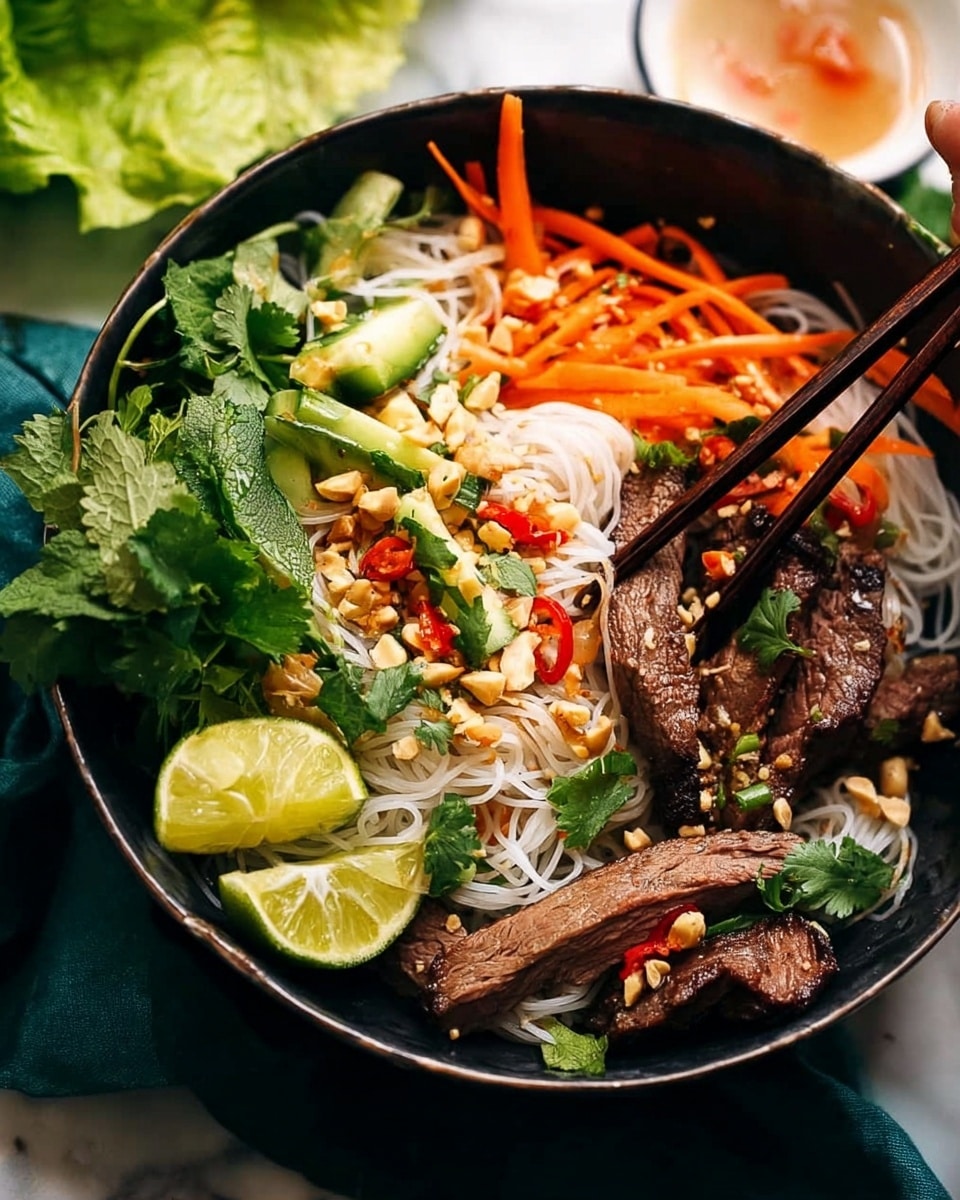 A black bowl sits on a white marbled texture, filled with a layered Asian noodle dish. At the bottom, thin white rice noodles form a soft base. On top, sliced grilled beef with a dark brown, slightly charred texture is scattered, sprinkled with crushed peanuts and small red chili pieces. Bright orange carrot sticks and fresh green cucumber slices add color and crunch beside the beef. A wedge of lime rests on the noodles, while fresh cilantro leaves peek through the layers. Wooden chopsticks rest on the bowl's edge, ready for serving. Photo taken with an iphone --ar 4:5 --v 7